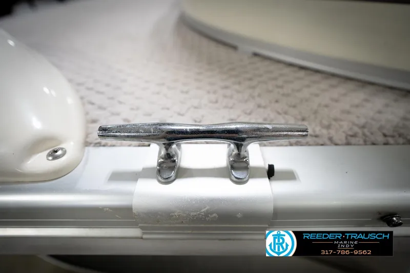 Slide: The Image of Close-up of a 2006 Bennington 2250RL boat cleat on textured surface. - 57