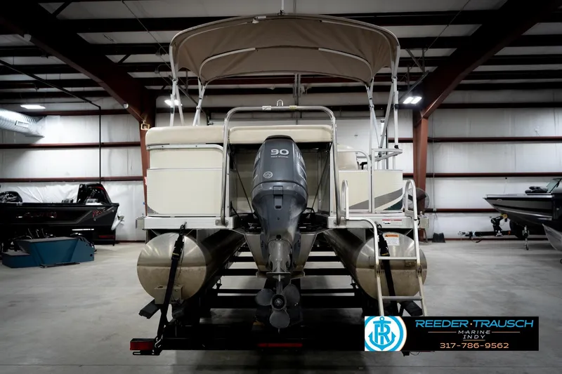 Slide: The Image of 2006 Bennington 2250RL pontoon boat with outboard motor in indoor storage facility. - 8