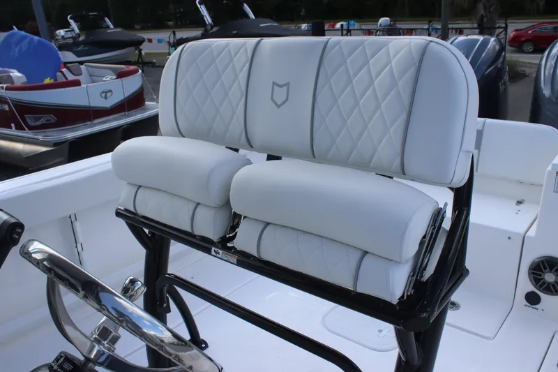 Slide: The Image of 2026 Sea Fox 268 Commander boat with white cushioned seating and steering wheel. - 13