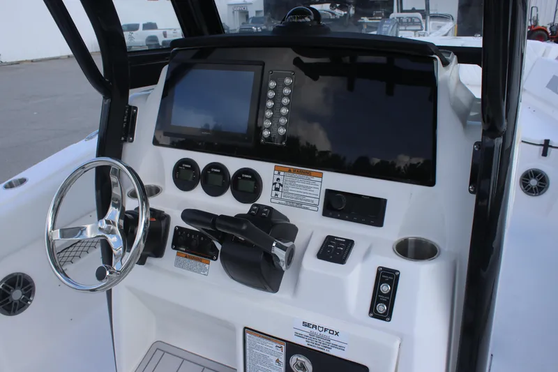 Slide: The Image of 2026 Sea Fox 268 Commander boat dashboard with steering wheel and control panel. - 14