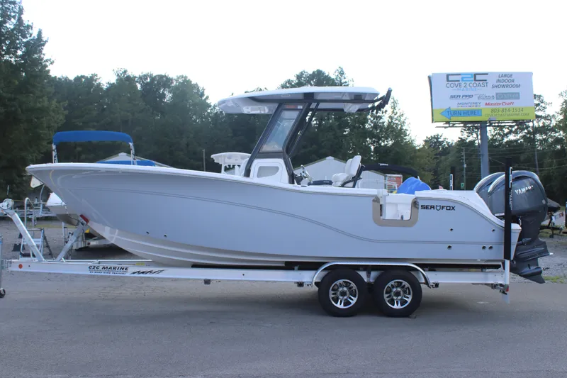 Slide: The Image of 2026 Sea Fox 268 Commander boat on trailer, side view, outdoor showroom setting. - 2