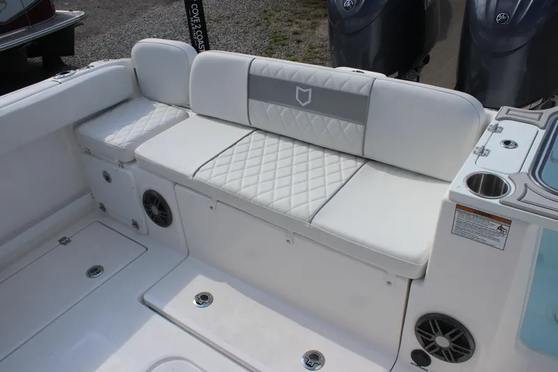 Slide: The Image of 2026 Sea Fox 268 Commander boat interior with white cushioned seating and storage compartments. - 21