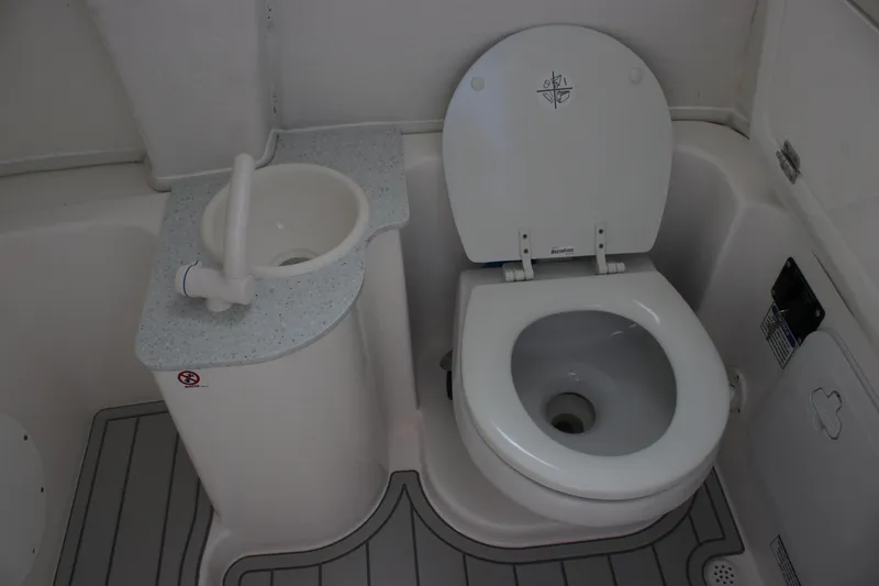 Slide: The Image of 2026 Sea Fox 268 Commander boat bathroom with toilet and compact sink. - 23
