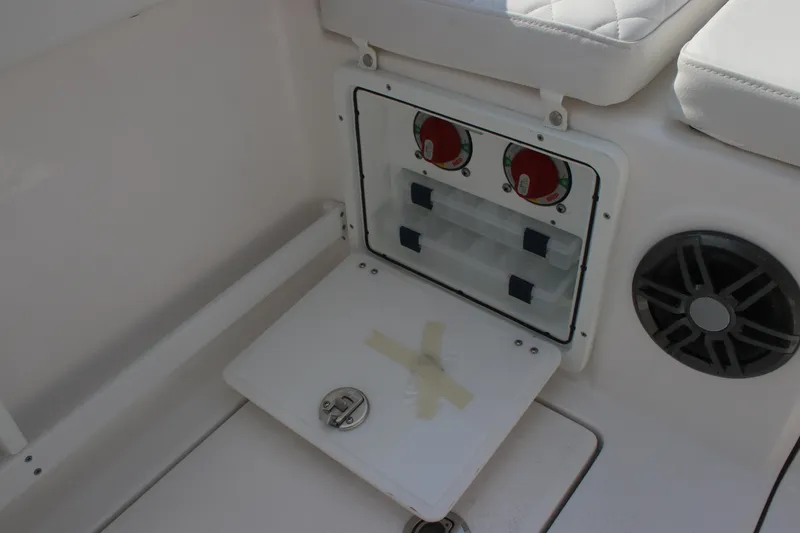 Slide: The Image of 2026 Sea Fox 268 Commander boat storage compartment with control panel and speaker. - 24
