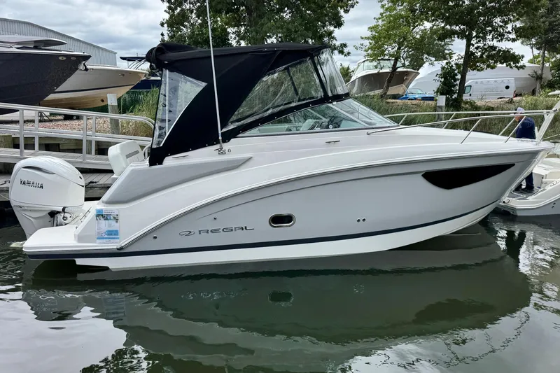 The Image of 2026 Regal 26 XO boat docked, featuring sleek design and Yamaha outboard motor. - 0