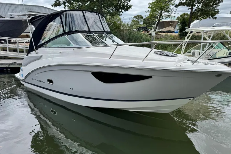 Slide: The Image of 2026 Regal 26 XO boat docked in calm waters, featuring sleek design and modern amenities. - 1