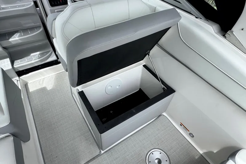 Slide: The Image of 2026 Regal 26 XO boat interior with open storage compartment and sleek seating design. - 13