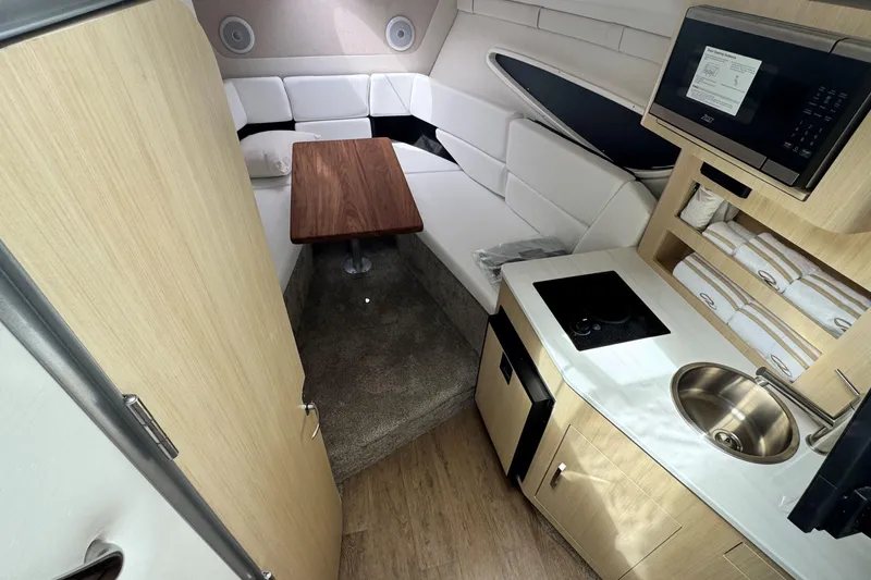 Slide: The Image of Luxurious interior of 2026 Regal 26 XO boat with kitchenette and seating area. - 21