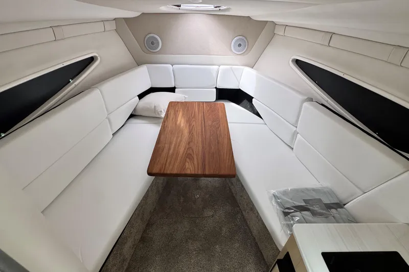 Slide: The Image of Interior of 2026 Regal 26 XO boat with white seating and wooden table. - 23