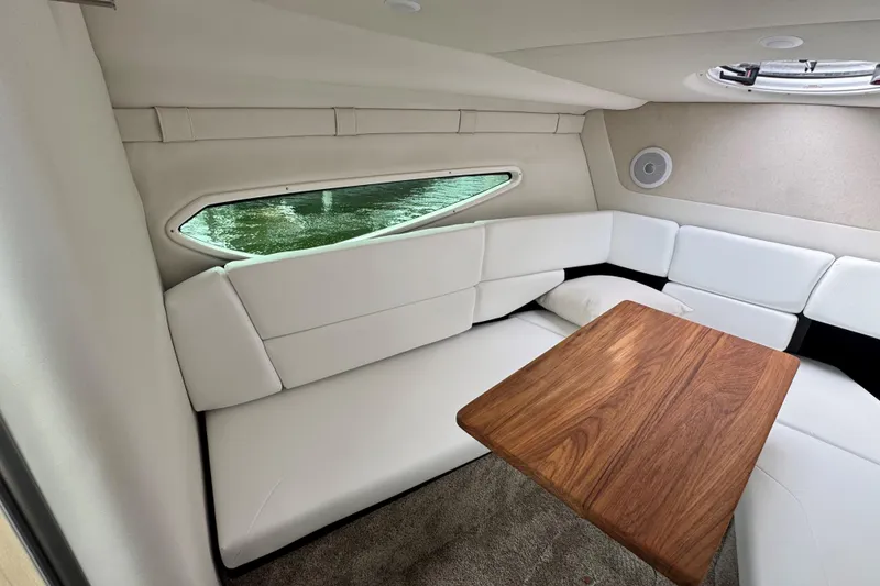 Slide: The Image of Interior of 2026 Regal 26 XO boat with white seating and wooden table. - 25