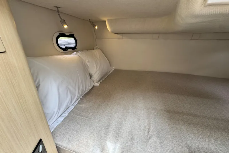 Slide: The Image of Cozy cabin interior of 2026 Regal 26 XO boat with comfortable bedding. - 29