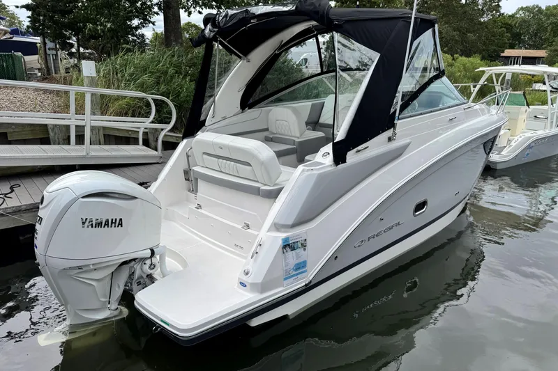 Slide: The Image of 2026 Regal 26 XO boat with Yamaha outboard engine docked in a marina. - 4