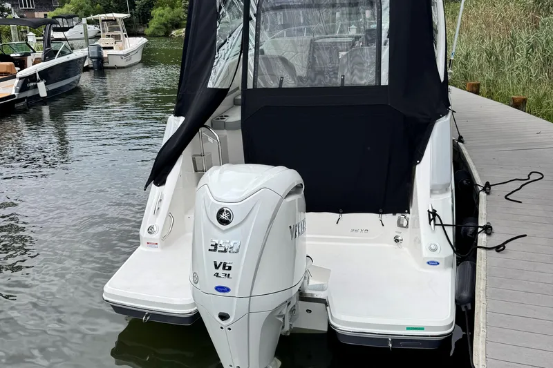 Slide: The Image of 2026 Regal 26 XO boat with Yamaha V6 engine docked at marina. - 5