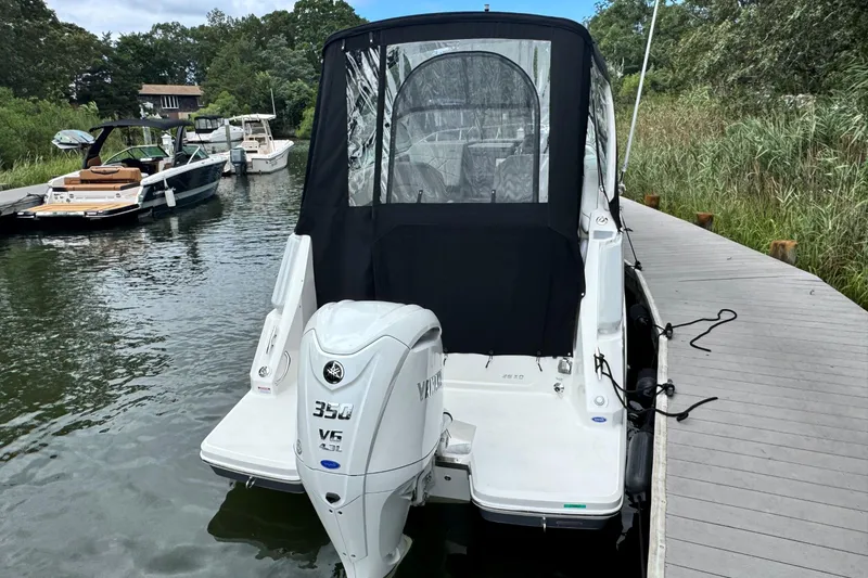 Slide: The Image of 2026 Regal 26 XO boat docked, featuring a Yamaha 350 V6 outboard engine. - 6
