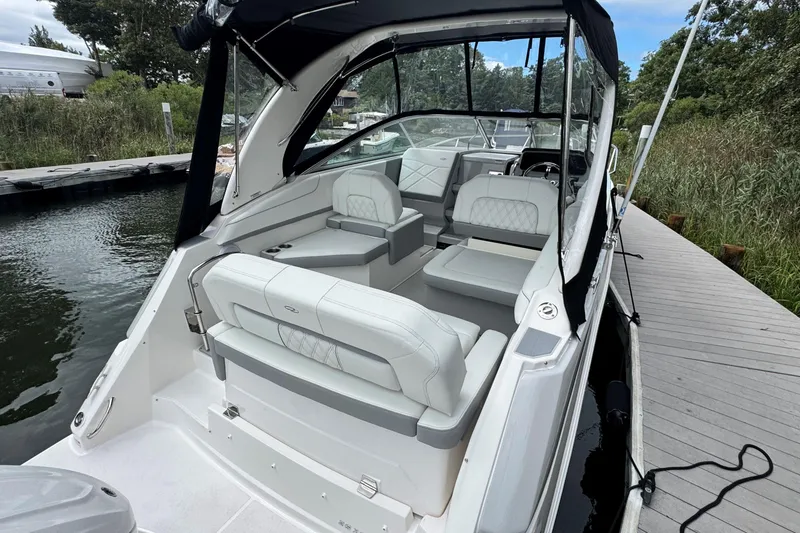 Slide: The Image of 2026 Regal 26 XO boat docked, featuring luxurious seating and sleek design. - 8