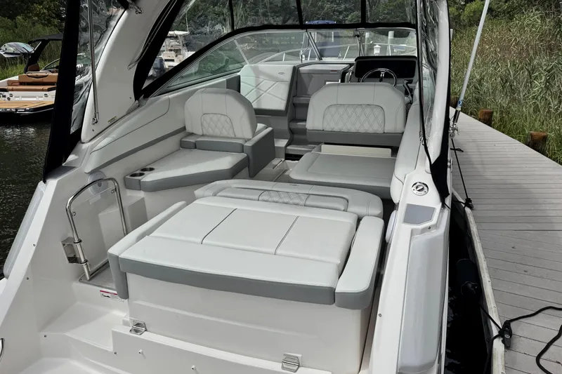 Slide: The Image of 2026 Regal 26 XO boat interior with luxurious seating and modern design at a dock. - 9