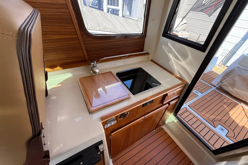 Slide: The Image of Interior of 2026 Ranger Tugs R-25 boat with compact kitchen area. - 11