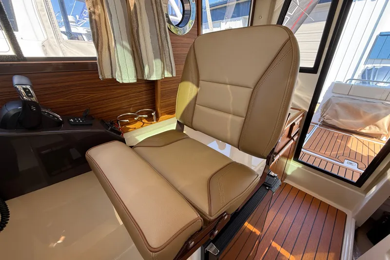 Slide: The Image of Luxurious interior seating of 2026 Ranger Tugs R-25 boat, featuring tan leather and wood accents. - 17