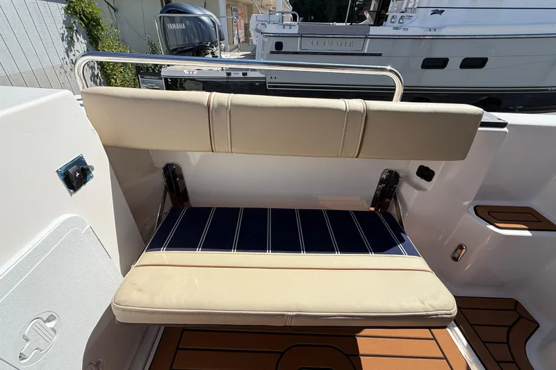 Slide: The Image of 2026 Ranger Tugs R-25 boat interior with foldable seat and teak flooring. - 27