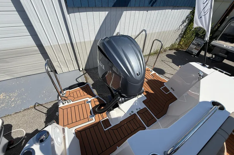 Slide: The Image of 2026 Ranger Tugs R-25 boat with Yamaha outboard motor and teak-style deck. - 3