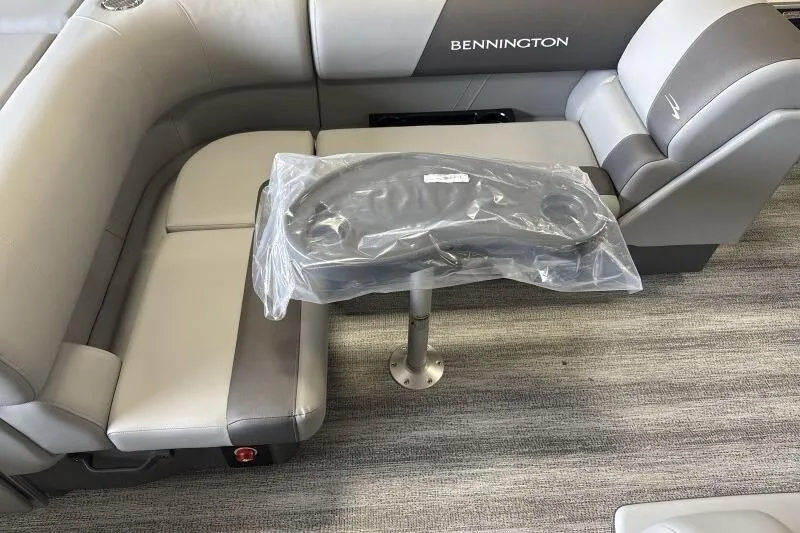 Slide: The Image of 2026 Bennington 23SL boat interior with gray seating and a small table. - 8