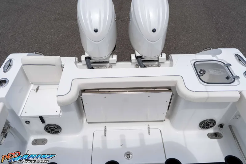 Slide: The Image of 2026 Sea Hunt Gamefish 25 boat deck with dual engines and fishing amenities. - 17
