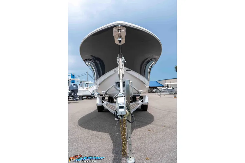 Slide: The Image of 2026 Sea Hunt Gamefish 25 boat on trailer, viewed from the front in a marina. - 2
