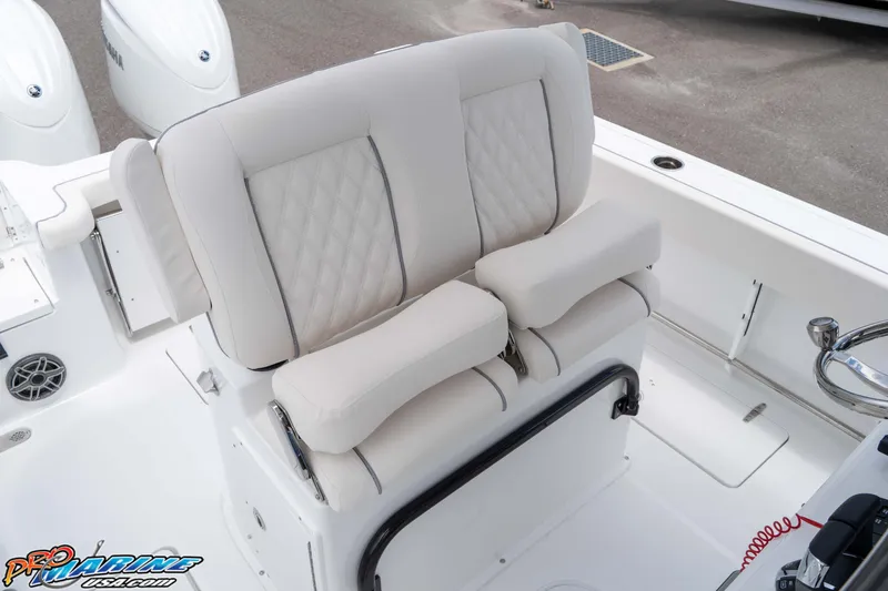Slide: The Image of 2026 Sea Hunt Gamefish 25 boat interior with cushioned seating and dual Yamaha engines. - 21