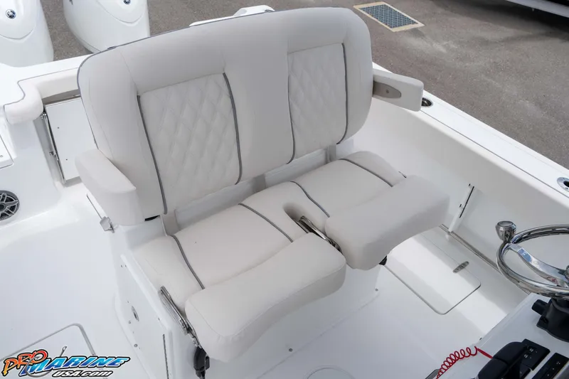 Slide: The Image of 2026 Sea Hunt Gamefish 25 boat interior with plush seating and steering wheel. - 22