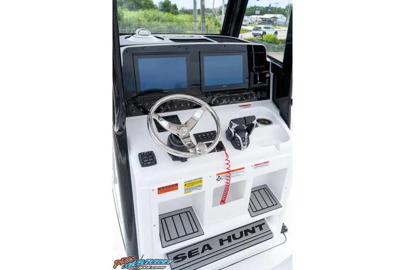 Slide: The Image of 2026 Sea Hunt Gamefish 25 helm with dual screens and modern controls. - 25