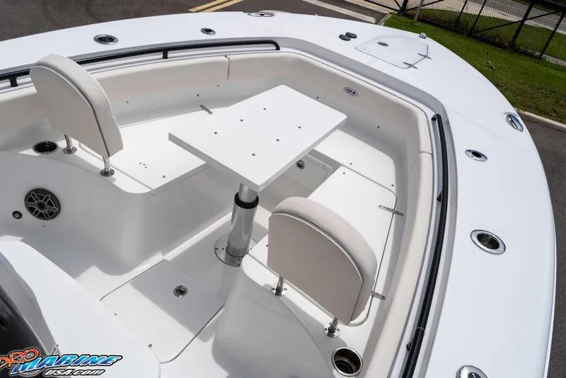 Slide: The Image of 2026 Sea Hunt Gamefish 25 boat interior with seating and table setup. - 27