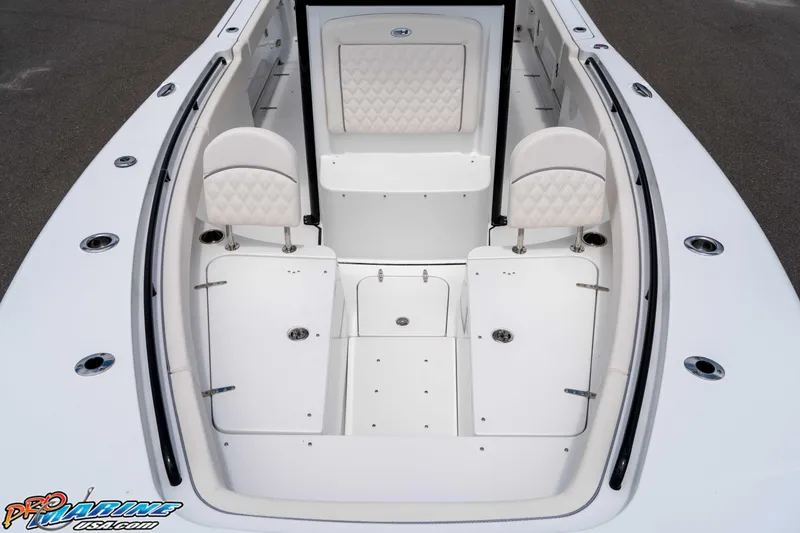 Slide: The Image of 2026 Sea Hunt Gamefish 25 boat interior with white seating and storage compartments. - 33