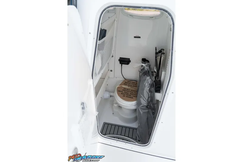 Slide: The Image of Interior of 2026 Sea Hunt Gamefish 25 boat, featuring a compact marine toilet. - 37