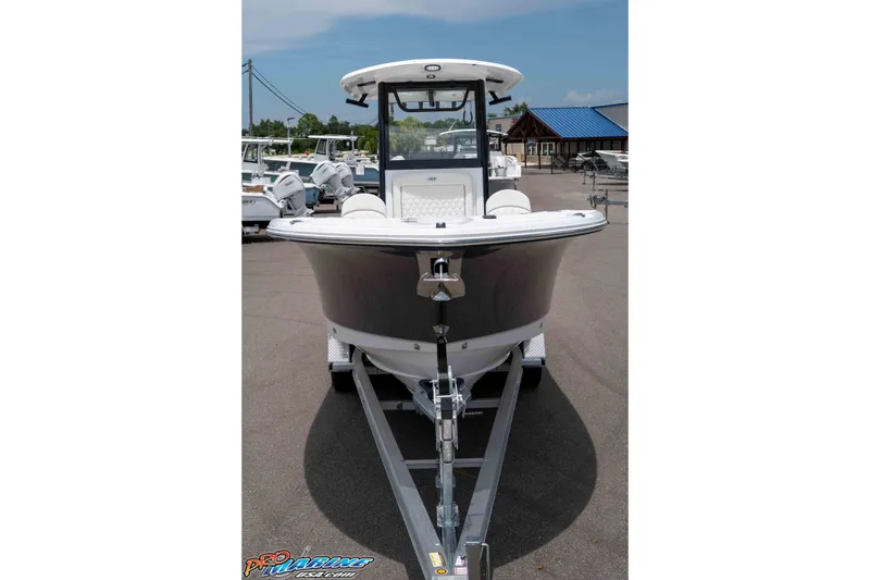 Slide: The Image of 2026 Sea Hunt Gamefish 25 boat on trailer, front view, parked outdoors. - 41