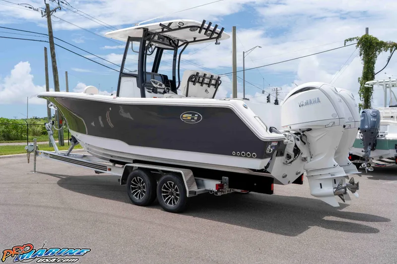 Slide: The Image of 2026 Sea Hunt Gamefish 25 boat on trailer, featuring dual Yamaha engines. - 6