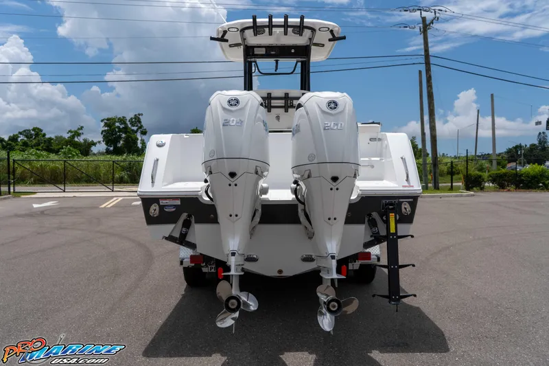Slide: The Image of 2026 Sea Hunt Gamefish 25 with dual Yamaha 200 engines, parked outdoors. - 7