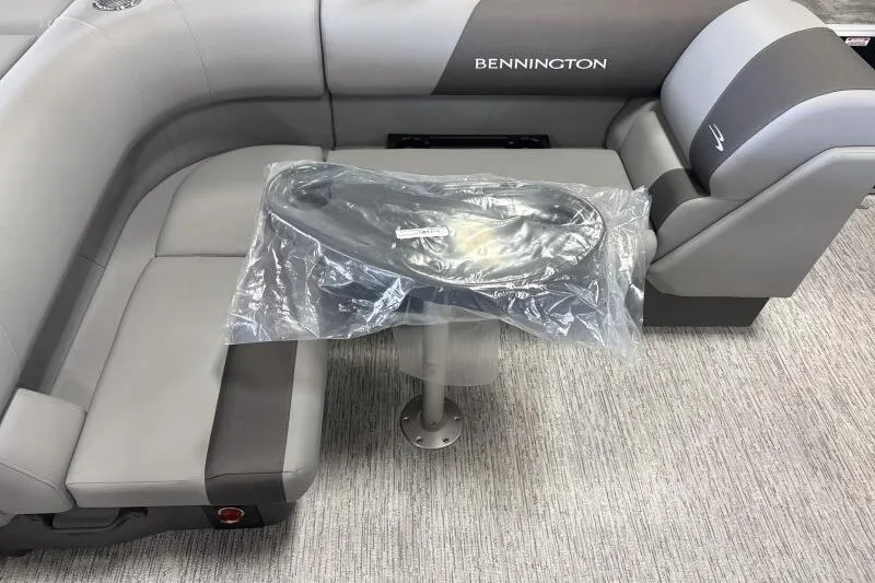 Slide: The Image of 2026 Bennington 23SL boat interior with gray seating and table. - 7