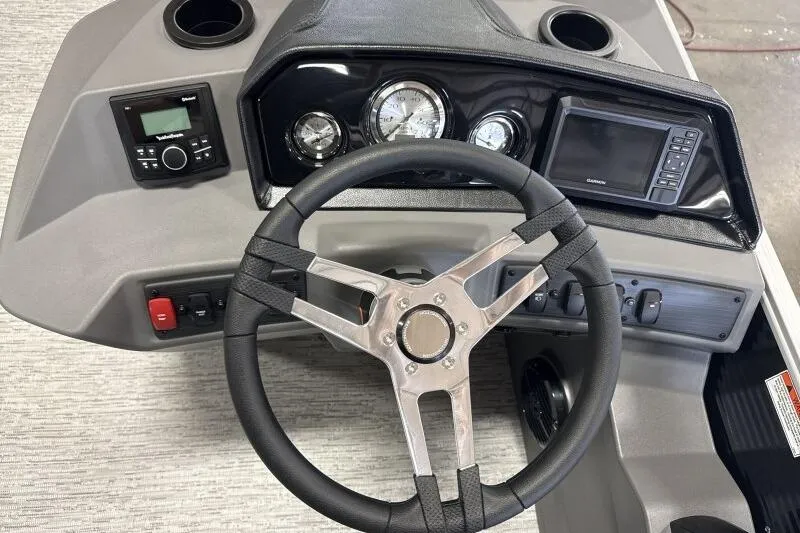 Slide: The Image of 2026 Bennington 23SL boat dashboard with steering wheel, gauges, and navigation system. - 8