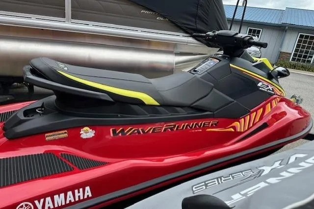 Slide: The Image of 2024 Yamaha WaveRunner EX Limited, red and black design, parked outdoors. - 10