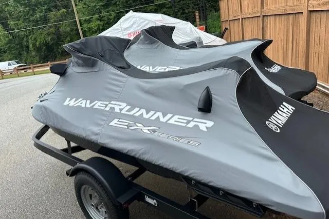 Slide: The Image of 2024 Yamaha WaveRunner EX Limited jet skis covered on a trailer. - 9