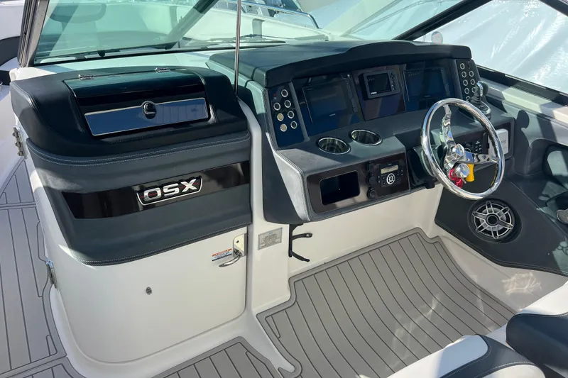 Slide: The Image of 2020 Chaparral 280 OSX boat cockpit with modern controls and steering wheel. - 11