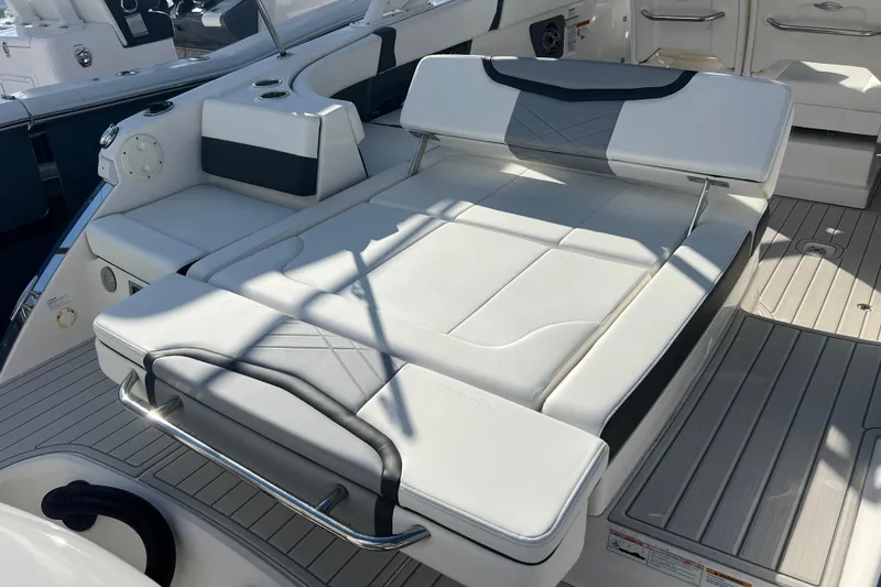 Slide: The Image of 2020 Chaparral 280 OSX boat interior with luxurious white seating and sleek design. - 23