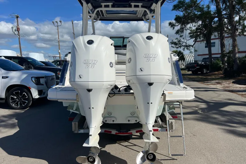 Slide: The Image of 2020 Chaparral 280 OSX boat with twin Yamaha 250 V6 engines, parked outdoors. - 4