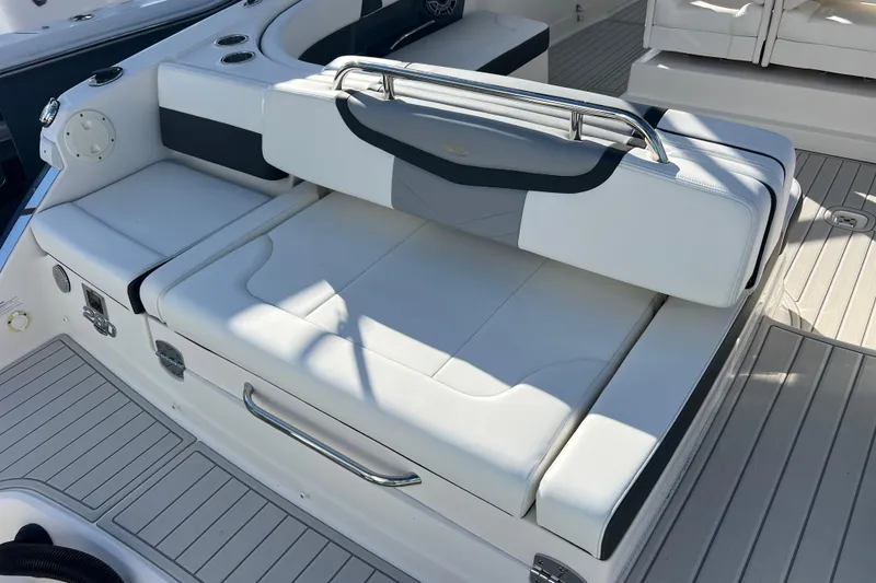 Slide: The Image of 2020 Chaparral 280 OSX boat interior with white cushioned seating and sleek design. - 7