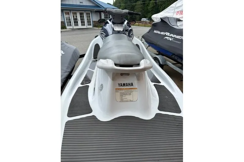 Slide: The Image of 2011 Yamaha WaveRunner VX Deluxe jet ski, rear view, parked outdoors. - 12