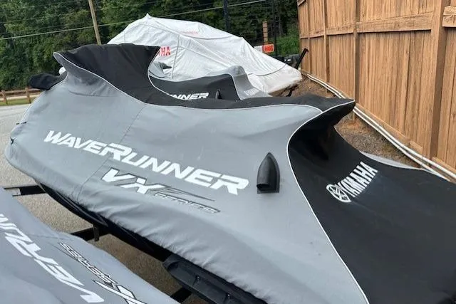 Slide: The Image of 2011 Yamaha WaveRunner VX Deluxe covered, parked near a wooden fence. - 13