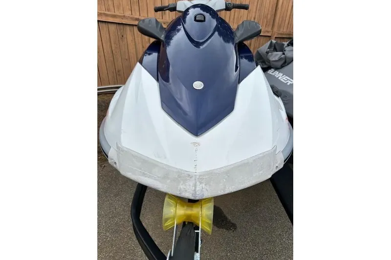 Slide: The Image of 2011 Yamaha WaveRunner VX Deluxe jet ski, blue and white, parked on a trailer. - 7