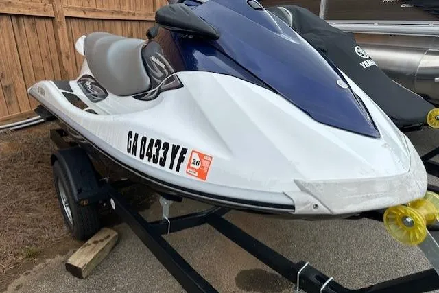 Slide: The Image of 2011 Yamaha WaveRunner VX Deluxe on trailer, white and blue, parked outdoors. - 8