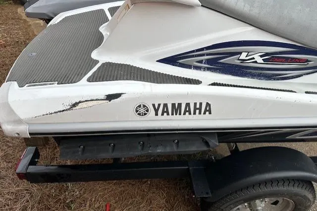 Slide: The Image of 2011 Yamaha WaveRunner VX Deluxe on trailer, showing side view with logo and minor scuff marks. - 9