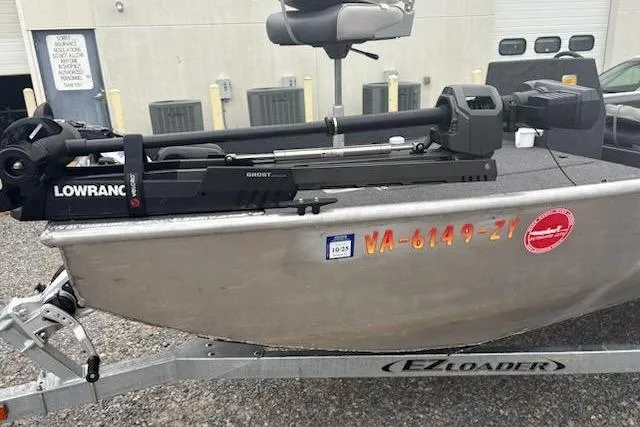 Slide: The Image of Fishing boat with Lowrance Ghost motor on EZ Loader trailer, Rhino JET 2023 model. - 5